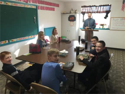 Junior high sunday school class with kids studying bible